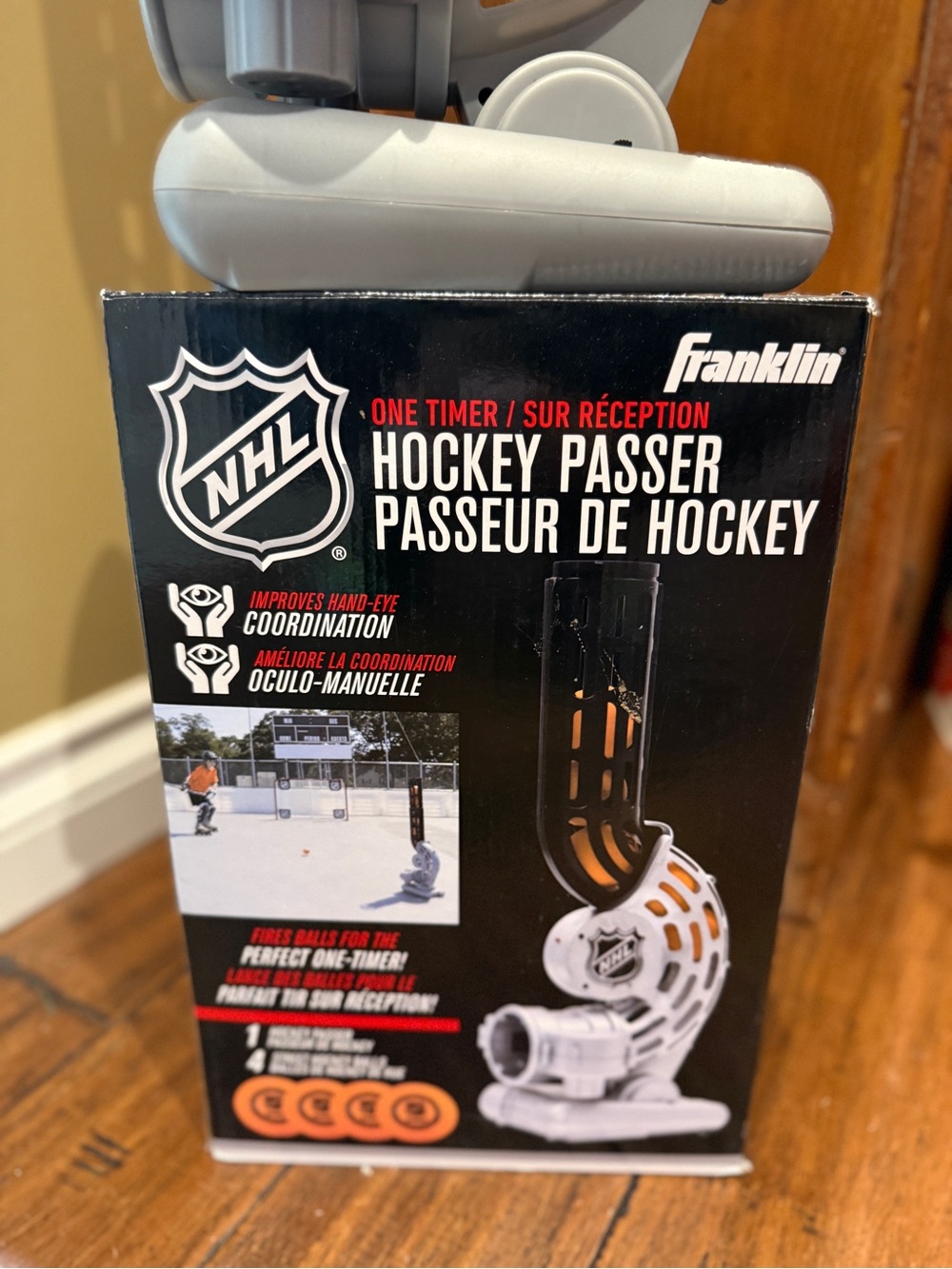 NHL Branded Hockey Ball Launcher in White and Black